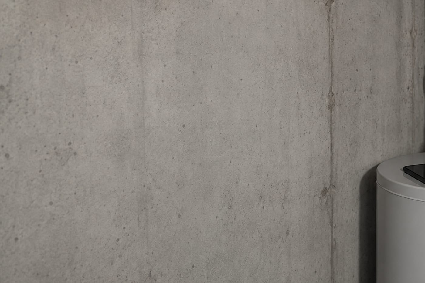 Water heater against a concrete wall, in a basement.